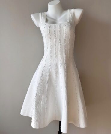 White Knit Midi Dress
A chic white knit dress featuring a flattering fitted silhouette, square neckline, and textured vertical detailing. Perfect for an elegant and effortless look.